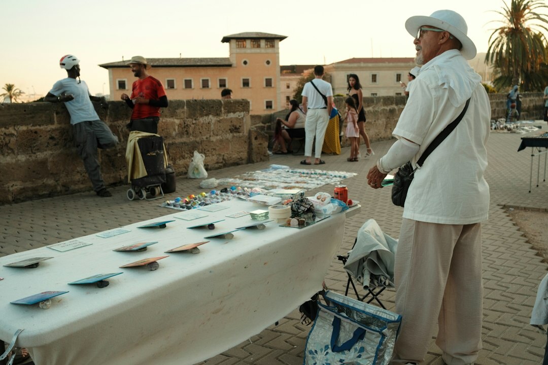 Two photographers reviewing printed photographs on an outdoor table