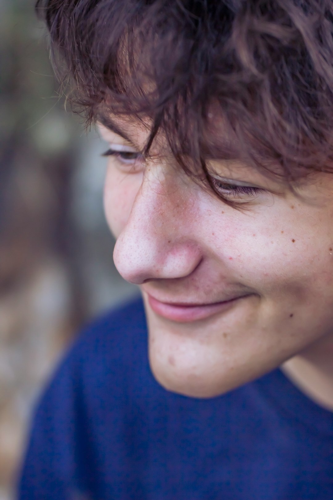 Close-up natural light portrait of a young man smiling